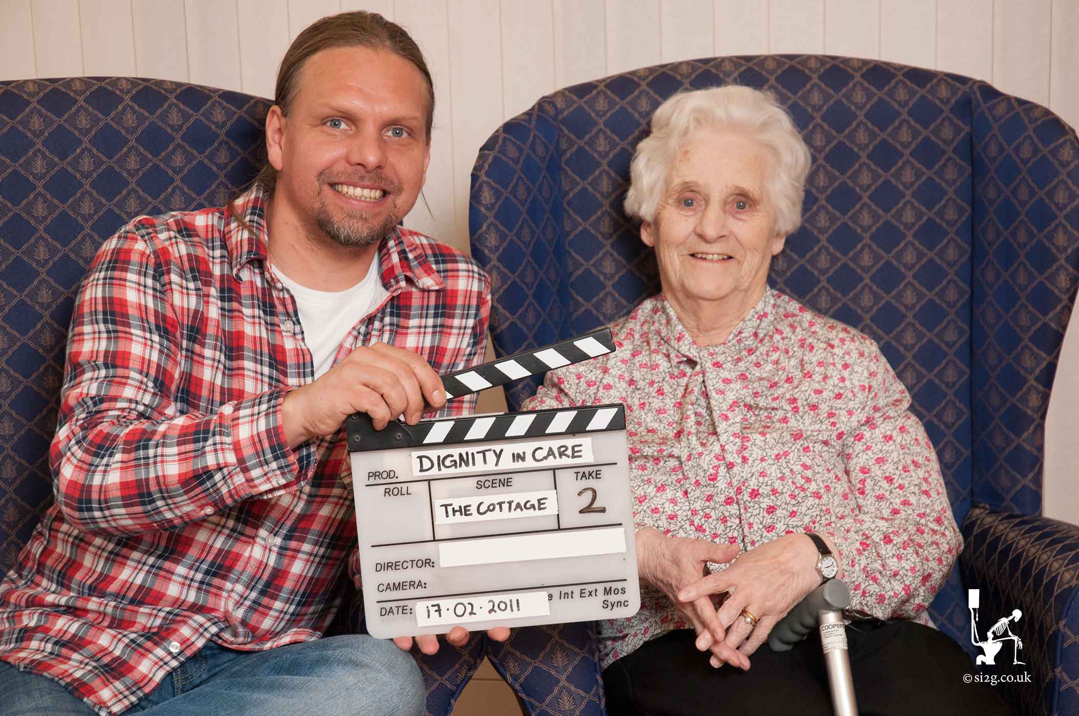 Clapper Board - Simon filming a resident of a care home.  Clapperboards are the best way of keeping your footage organised.  They are like labels for each and every shot and they are a sign that the crew have already planned what they would like to shoot.