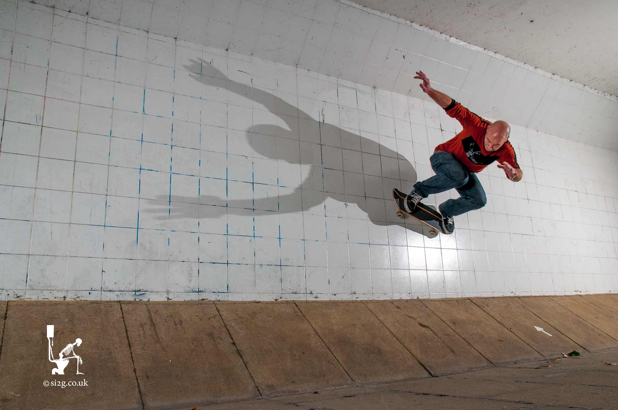 Skateboard Wallride - We set out specifically to capture this image of notorious skateboarder Martin Herrick performing a wallride on his skateboard, with his shadow stretched out across the wall.  In between busy waves of pedestrians using the under-pass Martin rode the wall, time-after-time, while minute adjustments were made to the lighting.