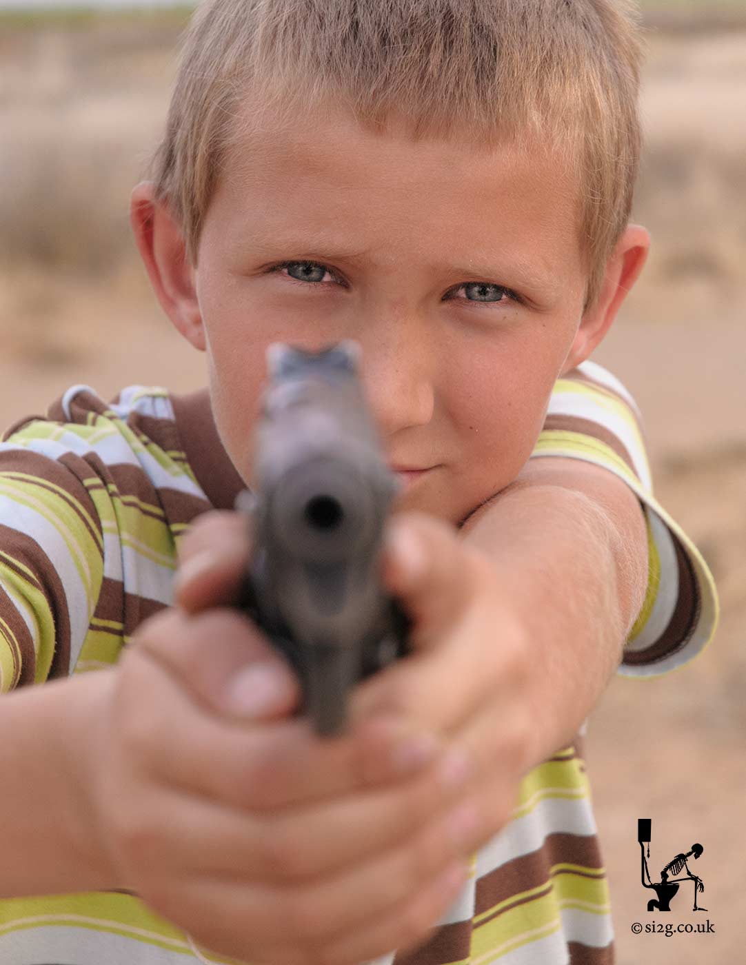 Child with Gun - This South African child has been taught to protect his village using live ammunition.