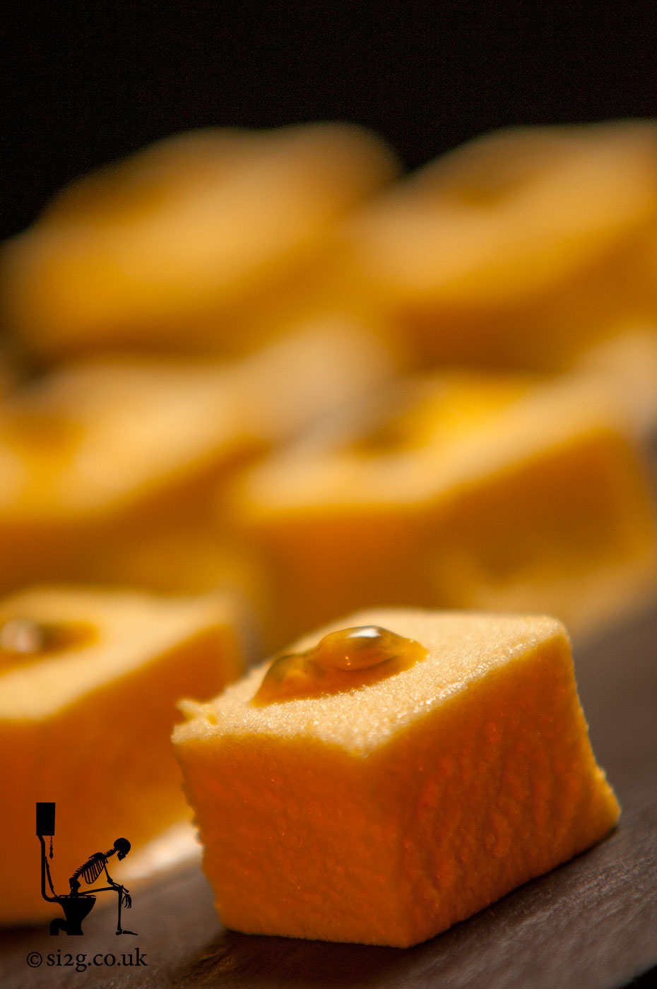 Passion Fruit Sponge Cake - Neatly-cut sponge squares, fresh from the oven and served on a slab of slate.